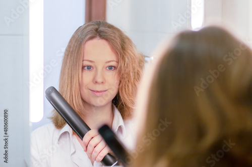 hair iron for straightening and smoothing, woman with before and after in the bathroom