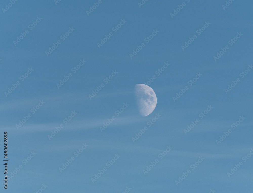 Moon in daylight with thin clouds a winter day in Stockholm Moon in daylight with thin clouds a winter day in Stockholm
