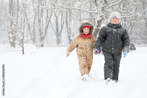 Boy and girl walking in winter park