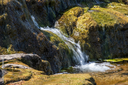 Swimming in the waterfall in the mountains