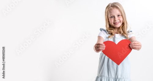 Beautiful girl holding a heart in her hands