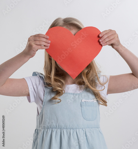 Beautiful girl holding a heart in her hands