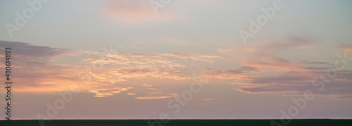 Pastel colors clouds on sunset background © shim11