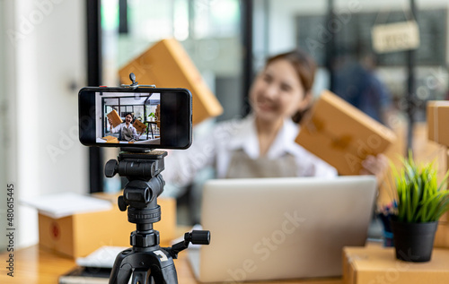Obraz na plátně Two women are online sellers, online sales company concept, two female salespeople are live selling products through the shop page and the order screen that customers have ordered and paid