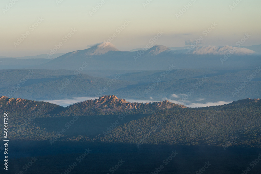 View of the sunrise mountains covered with clouds