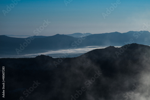 View of the silhouettes of the dark misty mountains