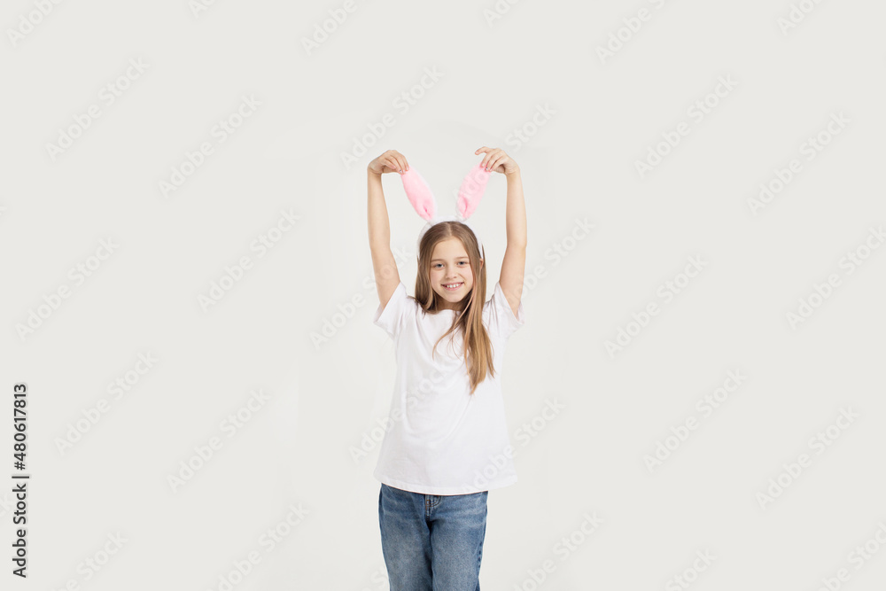 a teenage girl in a white t-shirt with rabbit ears, isolated on a white background a teenage girl in a white t-shirt with rabbit ears, isolated on a white background