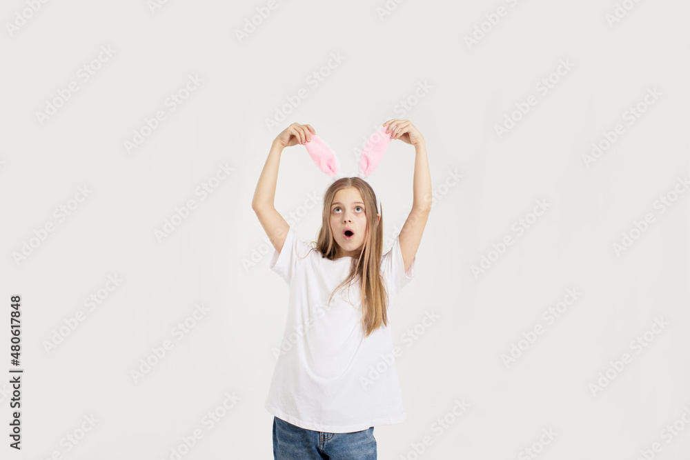 a teenage girl in a white t-shirt with rabbit ears, isolated on a white background a teenage girl in a white t-shirt with rabbit ears, isolated on a white background