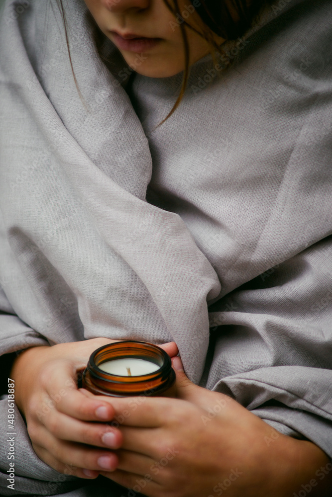 Fototapeta premium a candle in the hands of a girl close-up 