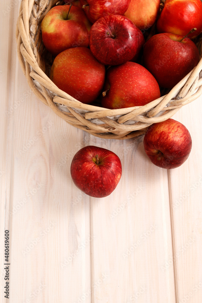 Red apples in wicker basket, wooden background. Red apples in wicker basket, wooden background.