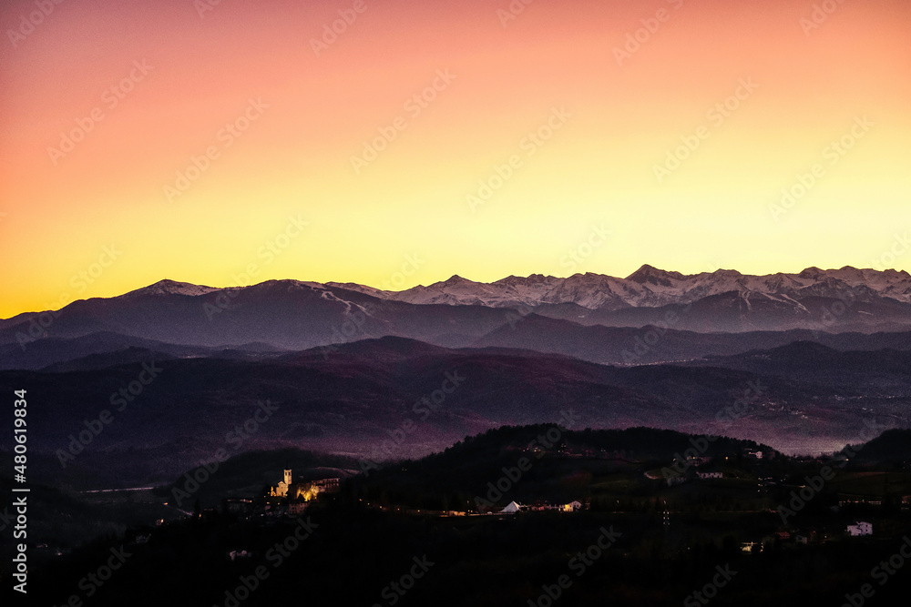 splendid sunset behind the Monviso mountain range, in Piedmont. in the foreground the valley of the Piedmontese Langhe