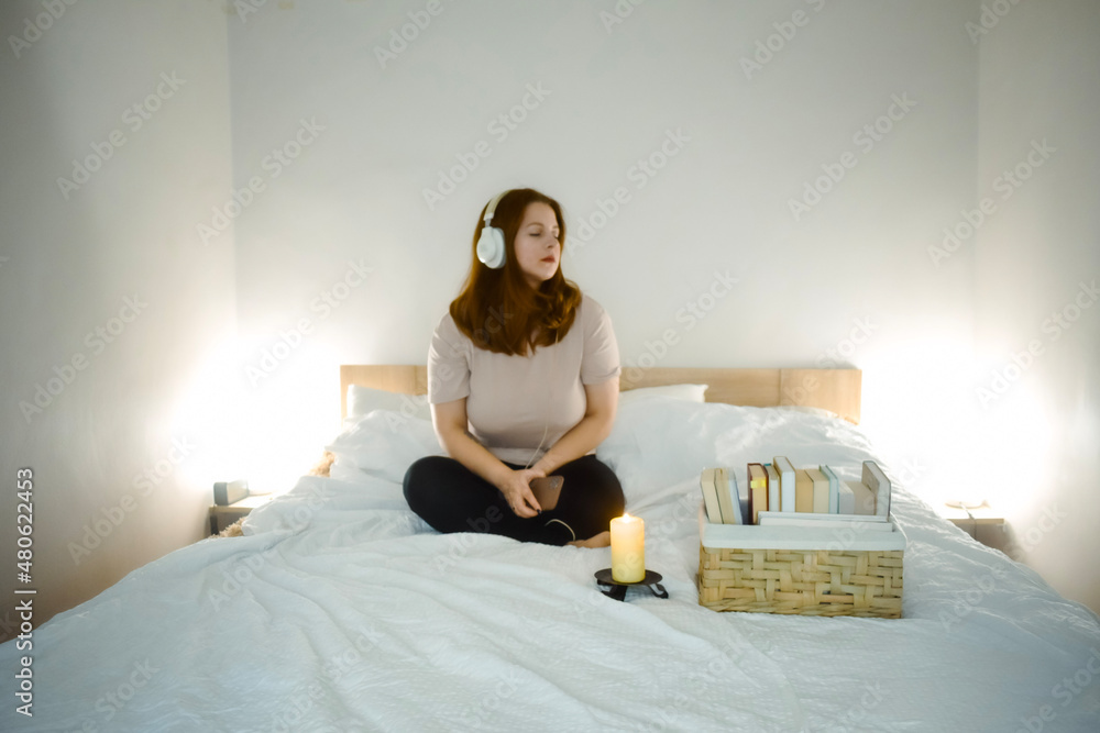 woman in bed listening headphones music 