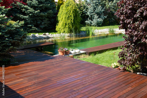 Natural home garden backyard with little pool lake, trees, ipe and cumaru wooden decks photo