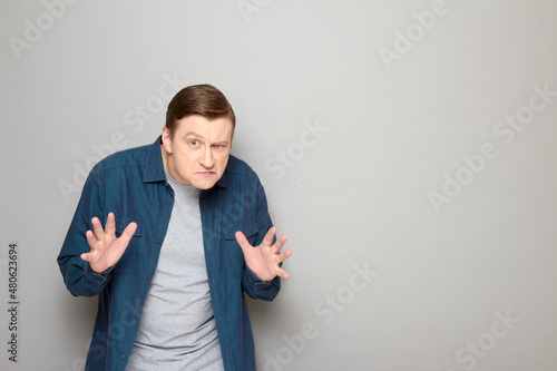 Portrait of angry disgruntled mature man with frowning face