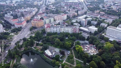 View of houses in Bartok area in Budapest. Park with a lake and cars on the road. Drone Video. Hungary. Europe	 photo