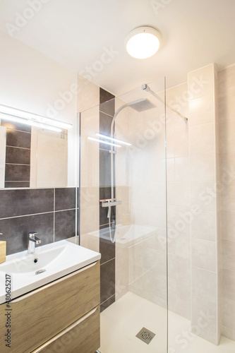 Beautiful bathroom  walk-in shower.Washbasin cabinet with a mirror and lighting  France - 25.08.2019 