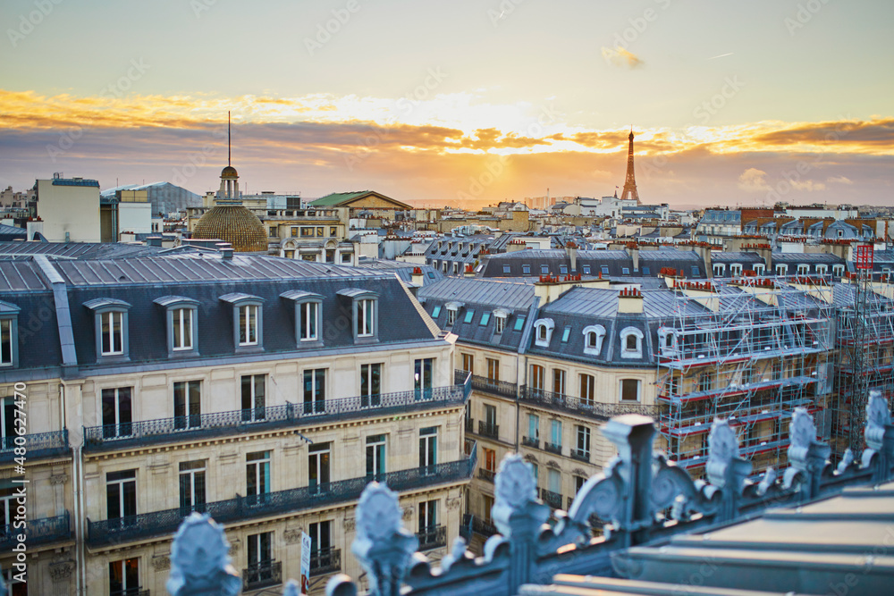 Beautiful Parisian skyline with roofs and dramatic sunset