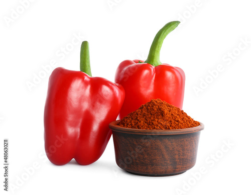 Valokuvatapetti Fresh bell peppers and bowl of paprika powder on white background