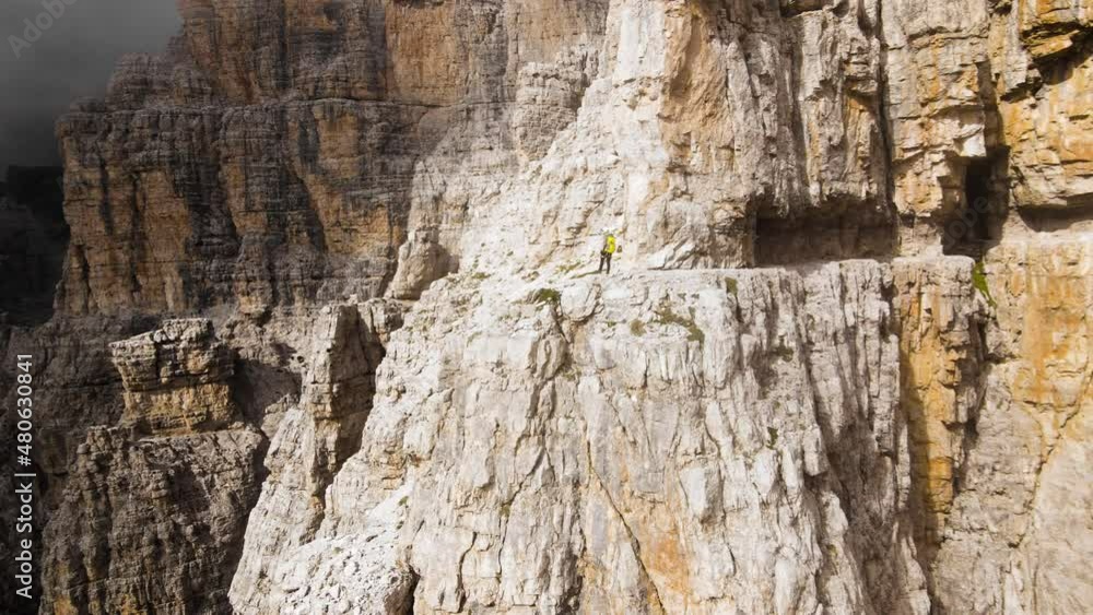 Hikers passing the via ferrata le bocchette trail. The most beatiful hikes in dolomites. Hikers passing the via ferrata le bocchette trail. The most beatiful hikes in dolomites.