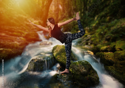 Woman doing yoga in a river