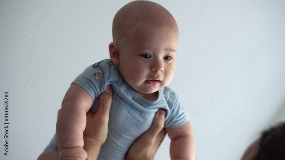 Close-up Of New Caucasian Father Sharing Tender Moment With Newborn Baby Child. Dad Have Fun Throws Infant Son Or Girl High Smiling. Kid Lifted Up With Outstretched Arms. Childhood, Parenthood Concept Close-up Of New Caucasian Father Sharing Tender Moment With Newborn Baby Child. Dad Have Fun Throws Infant Son Or Girl High Smiling. Kid Lifted Up With Outstretched Arms. Childhood, Parenthood Concept