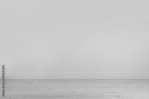 Empty white wall and wooden floor in room