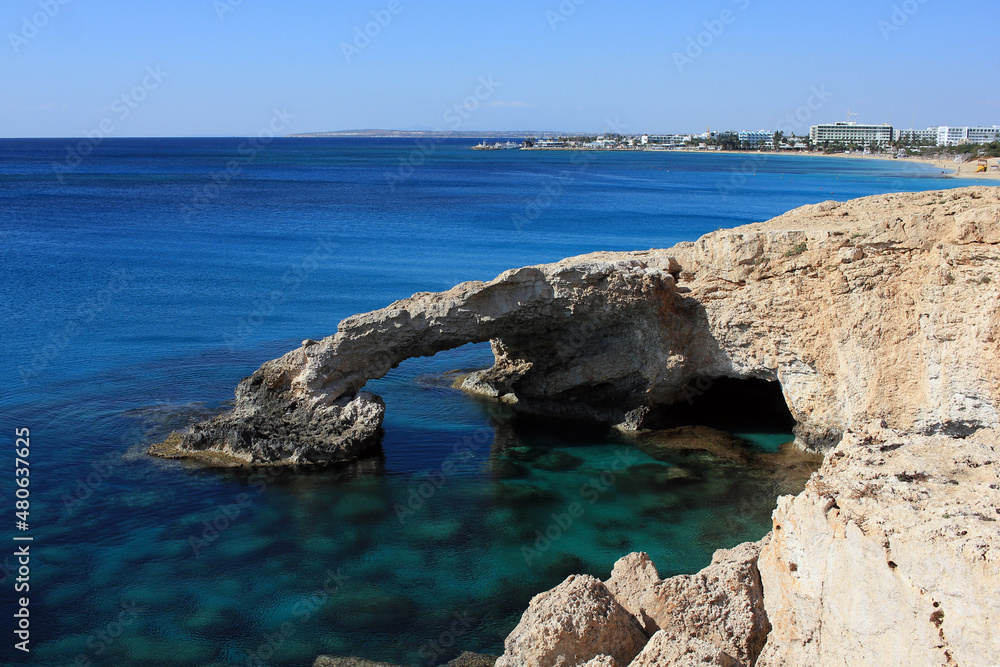 The bridge of love - rocky formation, touristic attraction with a city in background, in Ayia Napa, Cyprus