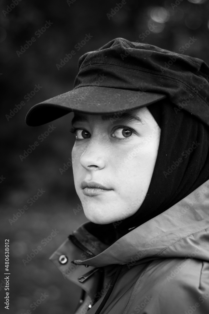 Fashionable Muslim woman in a black cap. Fashion industry. Face. Close up. Black and white photography