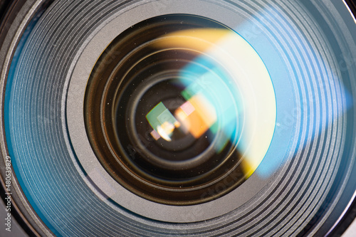 Dust particles inside and outside the camera lens. Dust particles trapped between lenses. Lenses have color flares.