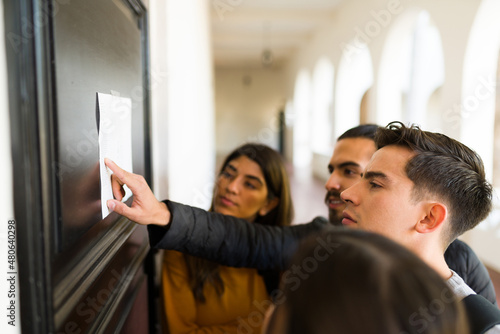 Side view of students checking the final grades