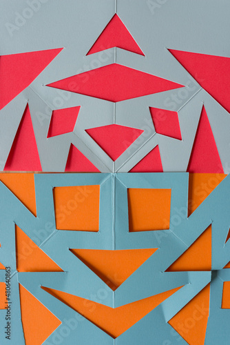 abstract composition with cut paper in orange, red, gray, and blue gray