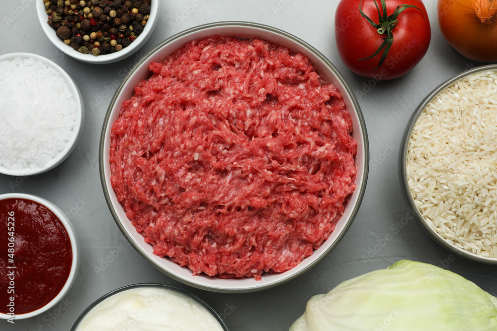 Set of ingredients for preparing stuffed cabbage rolls on light grey table, flat lay Set of ingredients for preparing stuffed cabbage rolls on light grey table, flat lay
