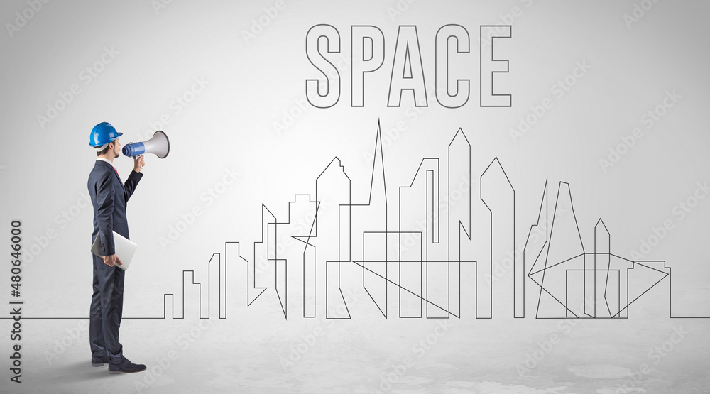 Businessman in hard hat holding blueprint