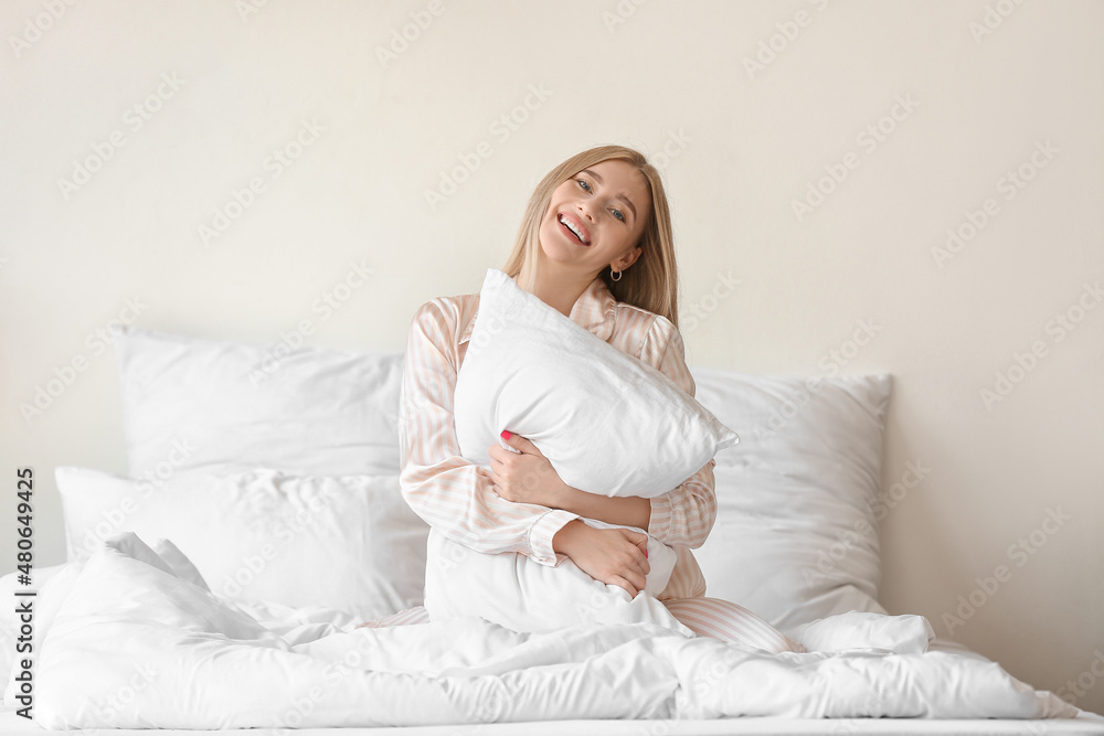 Morning of beautiful woman with pillow in bed