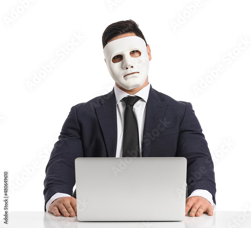 Hacker with laptop and mask...