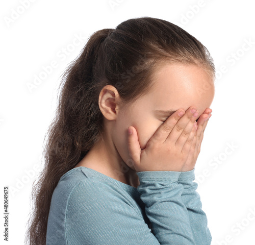 Little girl crying on white...