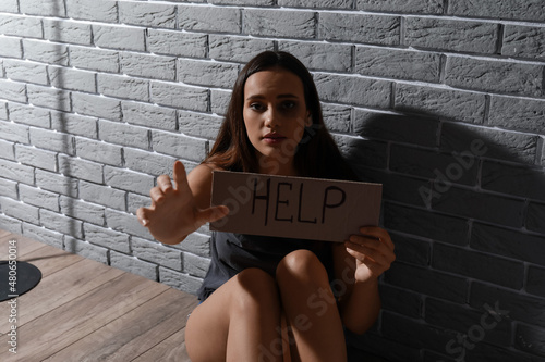 Scared young woman holding ...