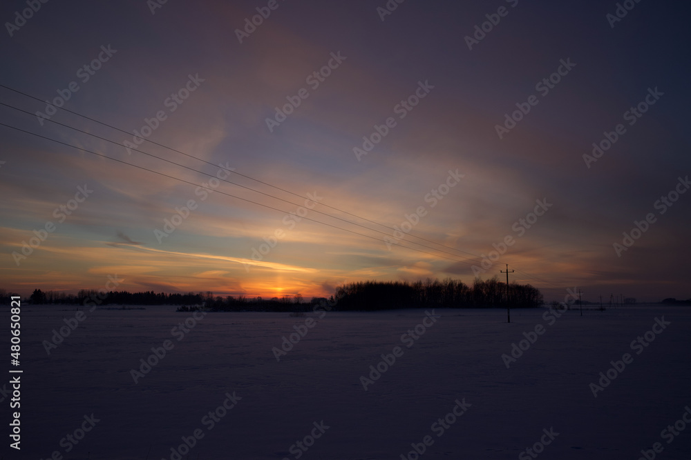 Colorful sky at sunset time with winter scenery.
