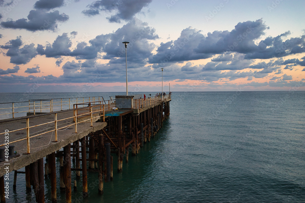 Naklejka premium Seascape with sunset view and pier. New Athos, Abkhazia