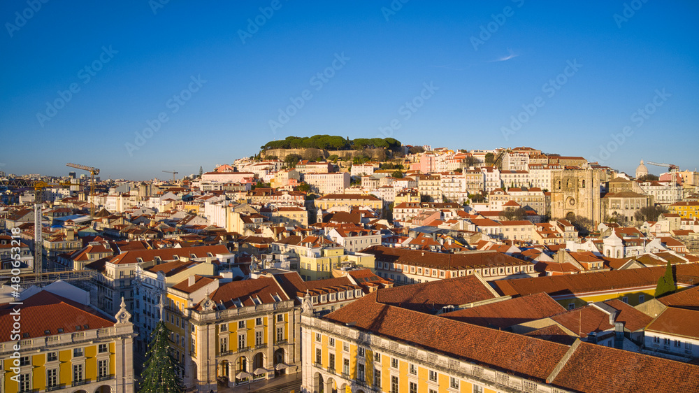 Lisbon, Portugal - January 13, 2022: Aerial drone view of Commerce Square in Lisbon, Portugal. Sao Jorge Castle in the background. Winter sunset.