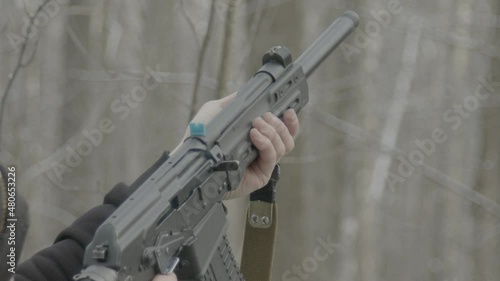 The shooter shoots from a gun in the forest. photo