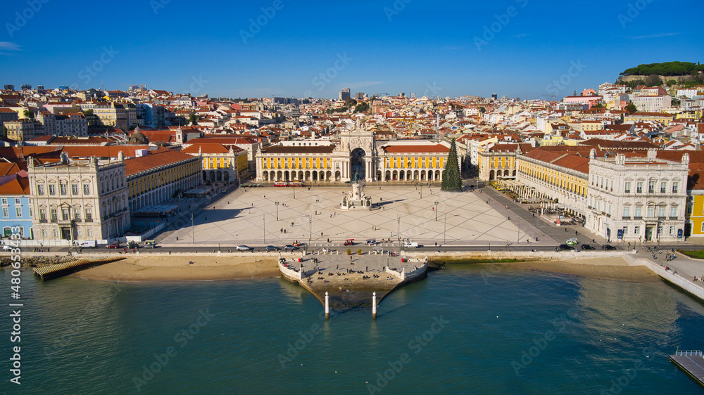 Aerial drone view of the Augusta Street Arch from Commerce Square in Lisbon, Portugal. Sunny day with blue sky. Joseph I portuguese king statue.