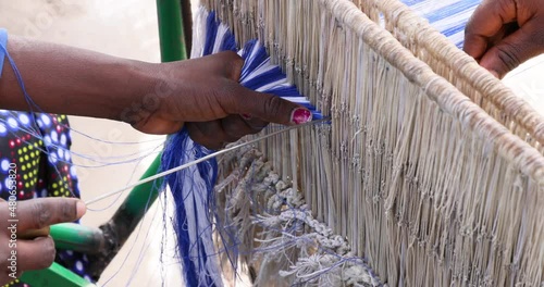 Kente cloth loom setup with thread Bolgatanga Ghana. Ghana, where the traditional cloth in Africa, Kente is made on hand looms, hand woven. The Kente is worn by the king of the Ashanti Kingdom. photo