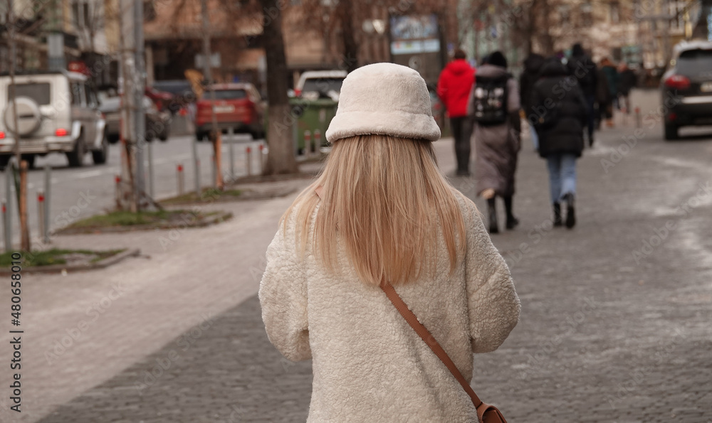 Blonde girl walking down the street