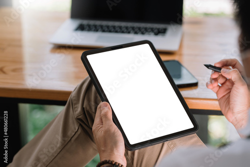 Close up view of man using tablet blank white screen for text message or information. photo