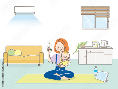 自宅でヨガマットに座る若い女性と赤ちゃん