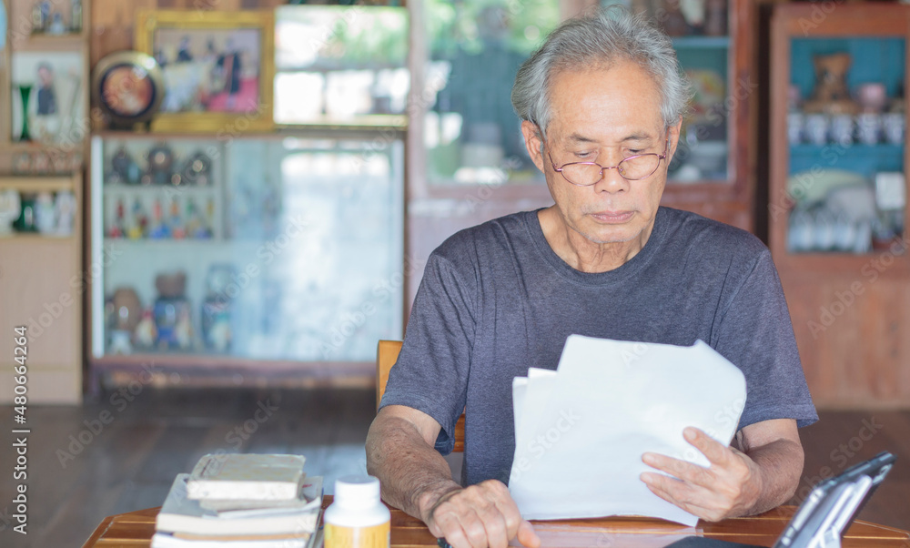 A middle-aged Asian elder working at home A middle-aged Asian elder working at home