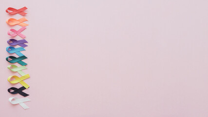 Multicolour ribbons on pink background, cancer awareness, World cancer day, world autism awareness day