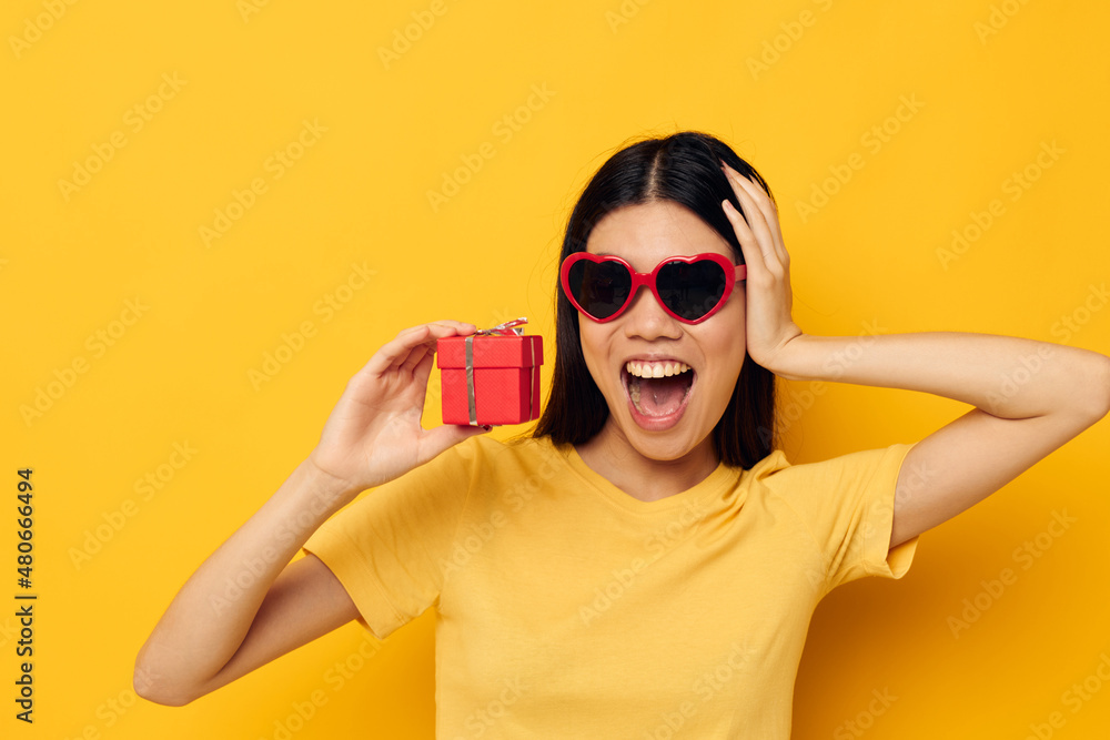 woman wearing sunglasses small gift box isolated background unaltered woman wearing sunglasses small gift box isolated background unaltered