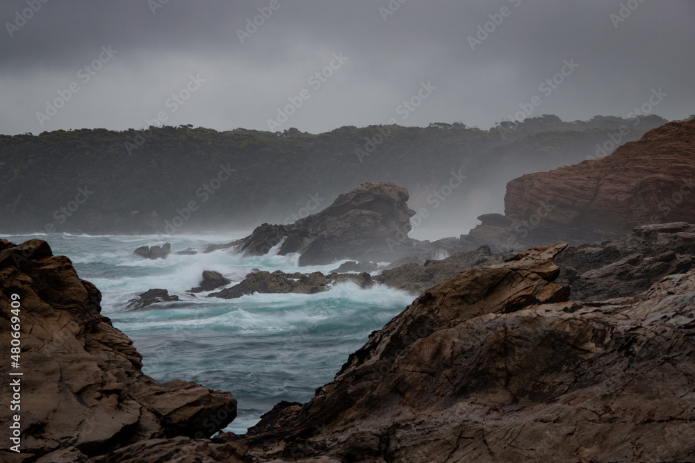 Rocky ocean coastline with stormy sky.